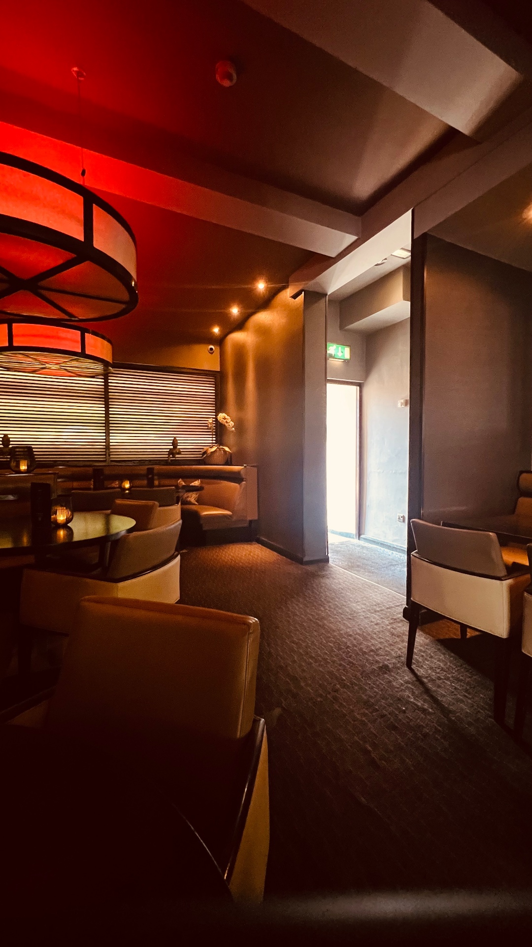 An intimate booth dining area at Zen, timber lined and warmly lit.